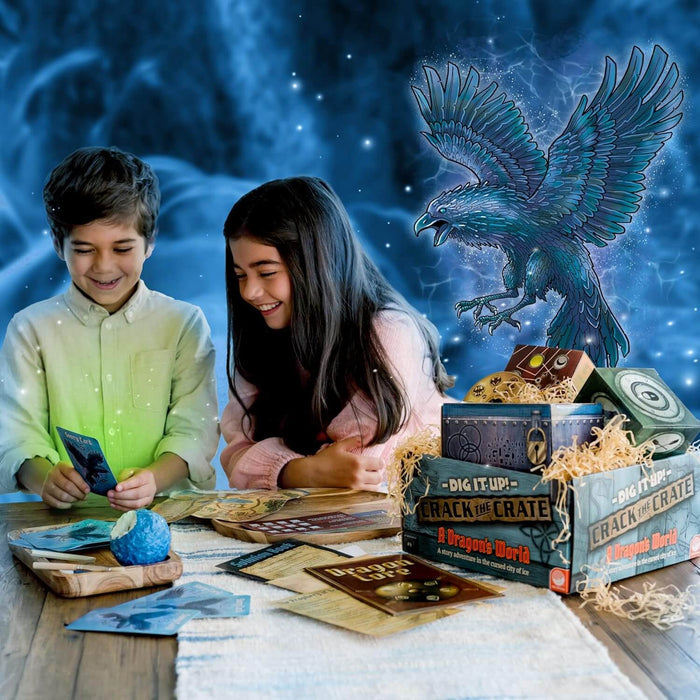 Two children play a dragon-themed mystery game with cards and a blue egg next to a themed crate and a blue bird graphic.
