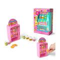 Pink and teal toy vending machines with miniature juice bottles and gold coins. Shown in and out of pink packaging.
