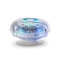 Transparent saucer-shaped bath light with glowing blue and green LEDs on a suction cup base.