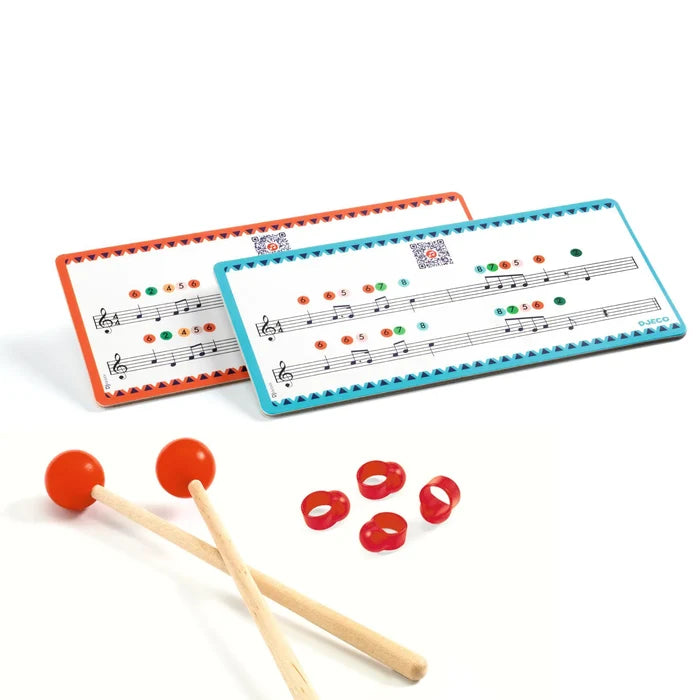 Two music score cards with colored notes, two wooden mallets with orange heads, and four red finger picks.