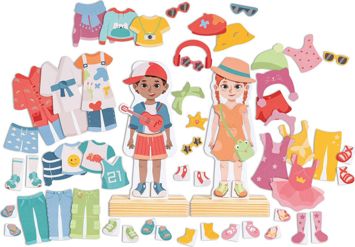 Two wooden stand-up figures surrounded by colorful magnetic clothing, hats, shoes, and accessory pieces.
