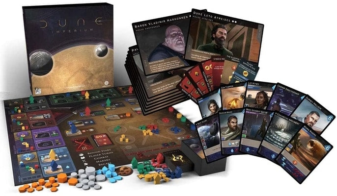 Dune Imperium game box, map board, character cards, and many small colorful wooden tokens and cubes.