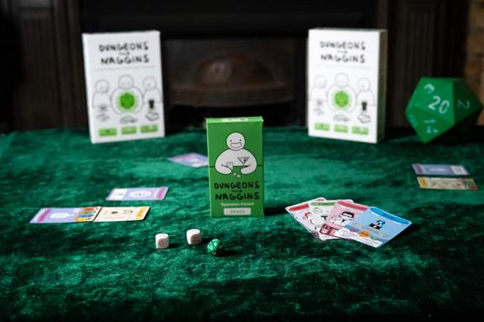 Small green box with a cartoon character on green velvet, surrounded by game cards, white dice, and a green d20.