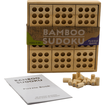 Light brown wooden Sudoku board with 9x9 grid, numbered bamboo pegs, and a white puzzle book.