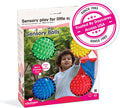 Box of four bumpy, colorful sensory balls in green, yellow, blue, and red, featuring a young child playing.