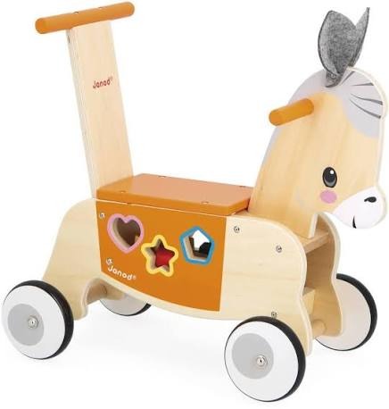 Wooden donkey ride-on toy with orange seat, gray felt ears, and side shape sorter on four white wheels.