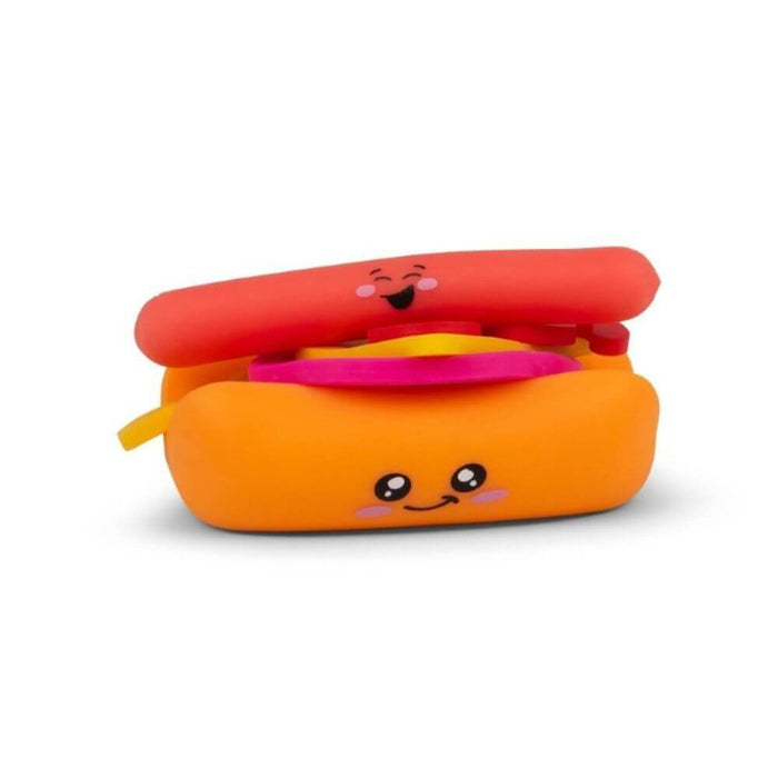 Colorful squishy hot dog toy with cute cartoon faces on the orange bun and red sausage, with pink and yellow fillings.