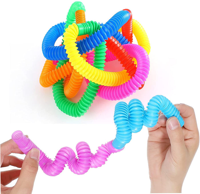 Colorful, accordion-style pop tubes in a tangled pile and being stretched and twisted by hands.