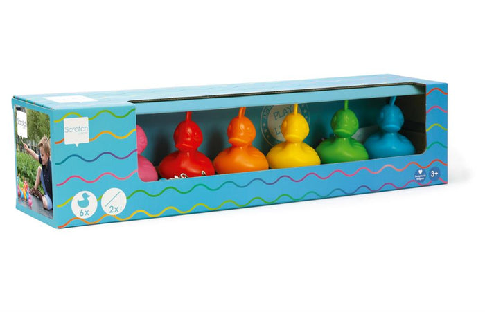 Six colorful plastic ducks in pink, red, orange, yellow, green, and blue inside a blue display box.