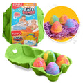 Four colorful, speckled egg-shaped bath bombs in a green egg carton with illustrated packaging.