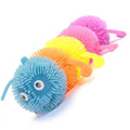 Colorful squashy caterpillar toy with spiked segments in blue, orange, yellow, and pink and large googly eyes.