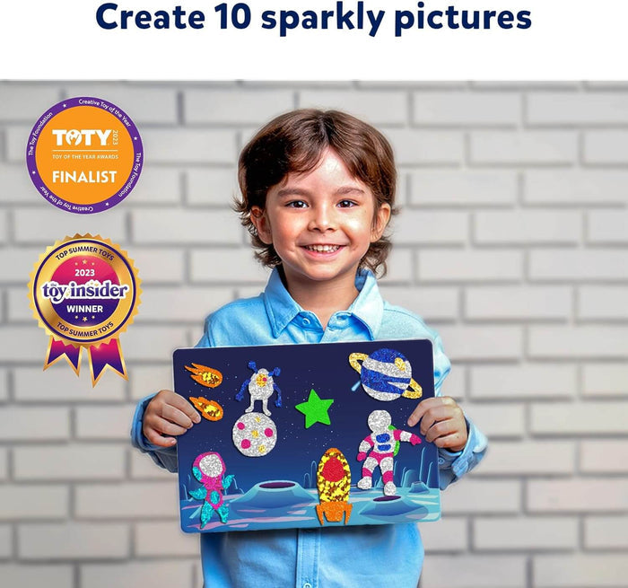 Smiling child holding a space-themed board with colorful, sparkly foil stickers of astronauts, rockets, and planets.