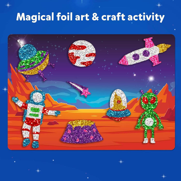 Colorful foil art craft featuring a glittery astronaut, alien, rocket, and UFO against a starry space backdrop.