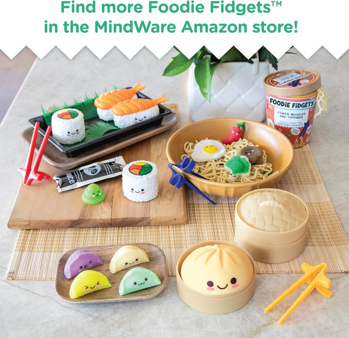 Cute sushi fidget set with smiling maki rolls, shrimp nigiri, wasabi, and red training chopsticks on a black tray.
