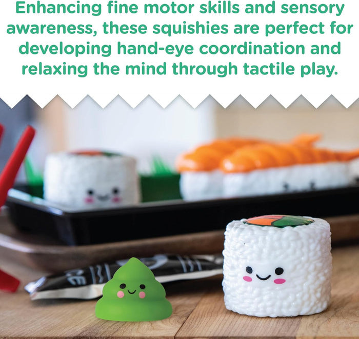 Smiling sushi squishies, including green wasabi, maki rolls, and nigiri, arranged on a wooden table with a tray.