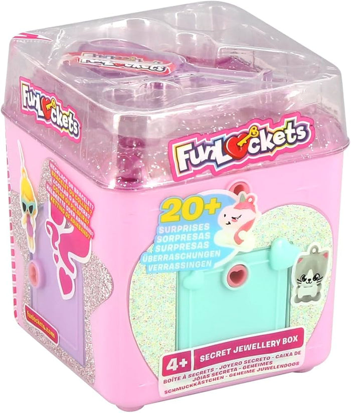 Pink cube toy jewelry box with heart-shaped keyholes, teal doors, and clear lid showing charms inside.