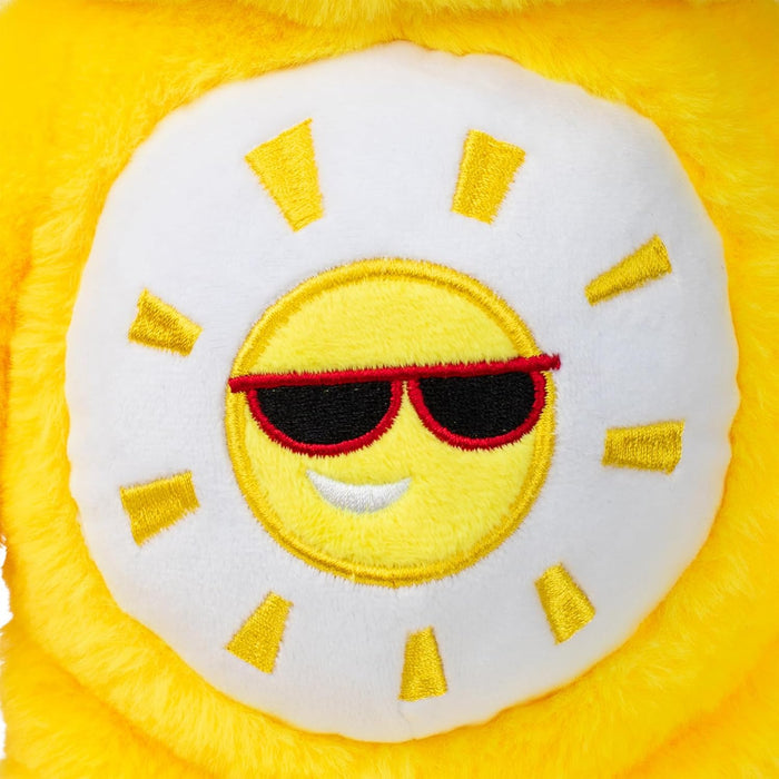 Embroidered yellow sun with red sunglasses and a smirk on a white belly badge of a yellow plush bear.