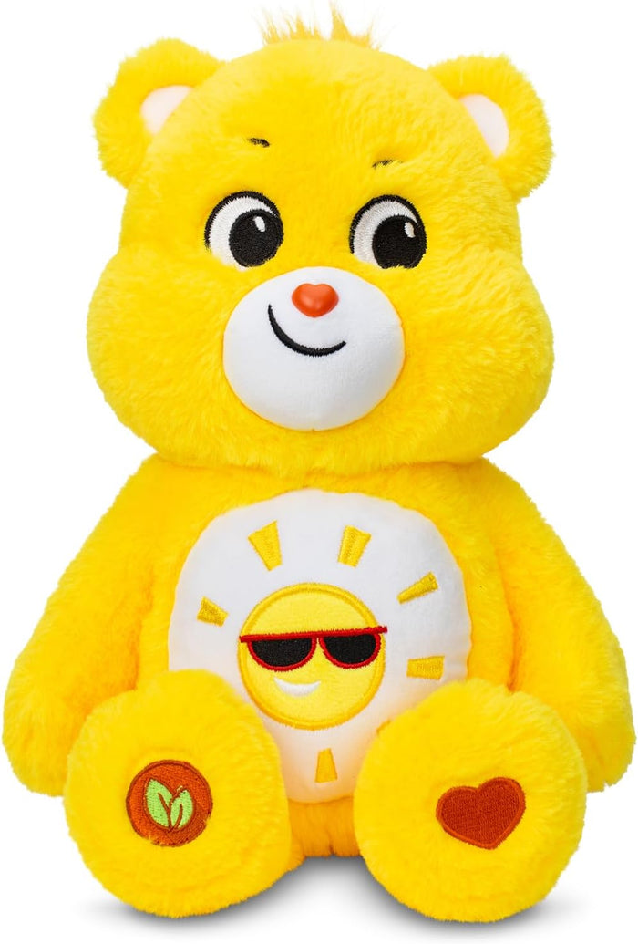Bright yellow plush bear with a sun wearing sunglasses on its white belly and a red heart on its paw.