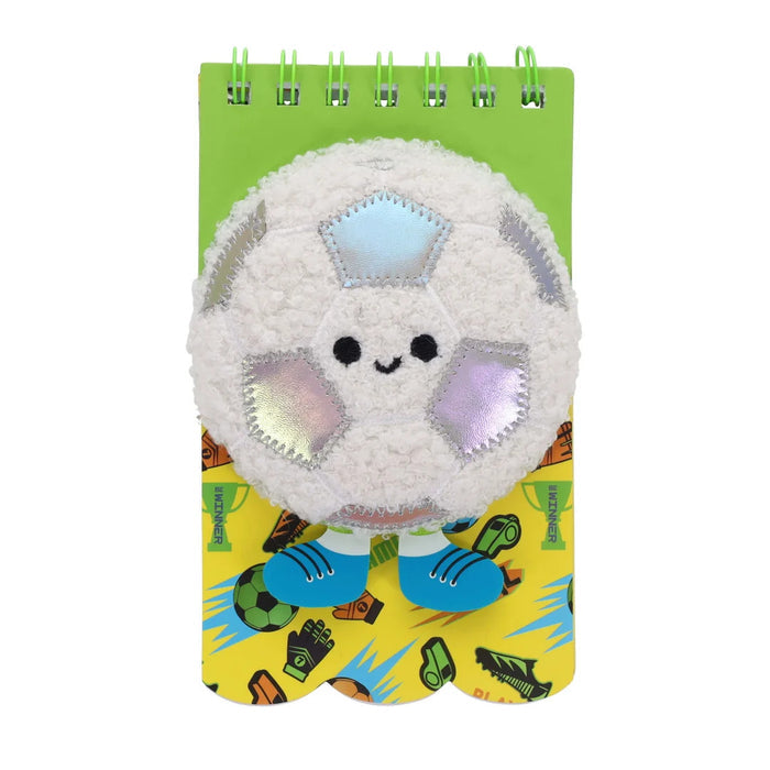 Spiral notebook with a white fuzzy soccer ball character, blue shoes, and a green and yellow football-themed cover.