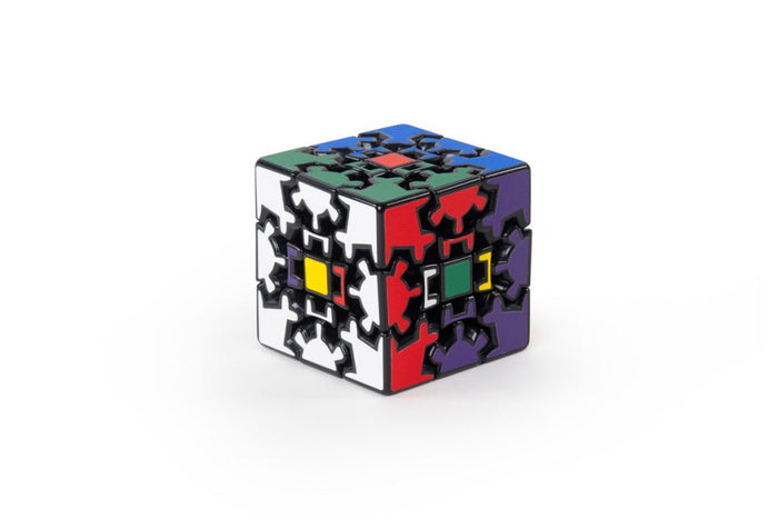 Multi-colored 3x3 puzzle cube with interlocking gear-shaped pieces on a black frame against a white background.