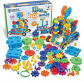 Product box with colorful plastic gear pieces, square bases, and a tall built tower in bright blue, green, and orange.