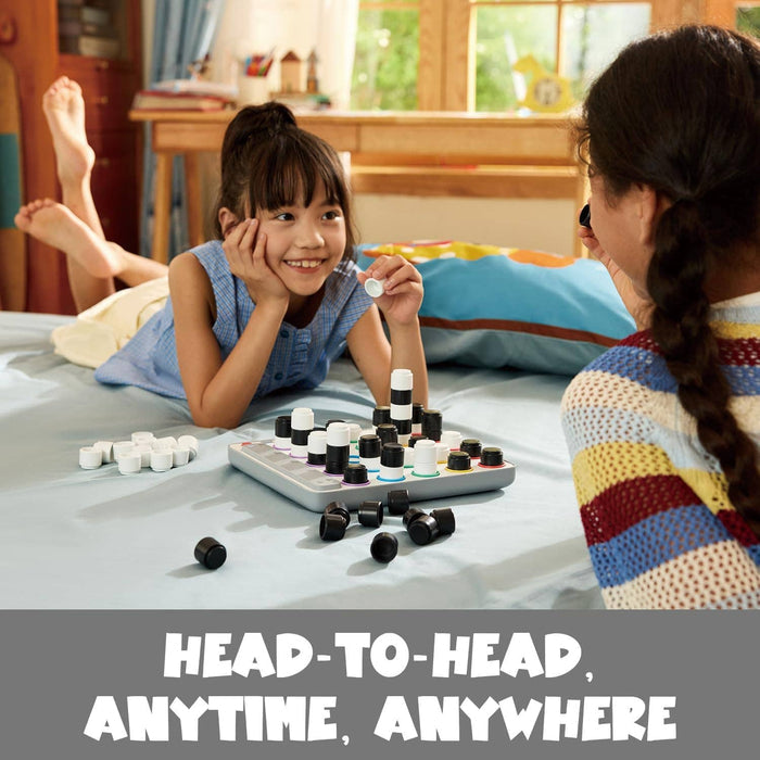 Girl and woman play a 3D game on a bed with black and white stackable pieces on a square grey electronic board.