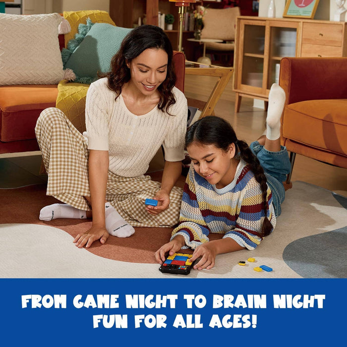 A woman and girl sit on a rug playing with a handheld electronic slide puzzle featuring colorful tiles.