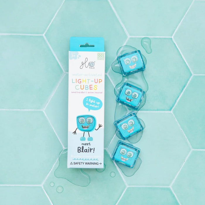 Four translucent blue cubes with faces in water next to a light blue box on teal hexagonal tiles.