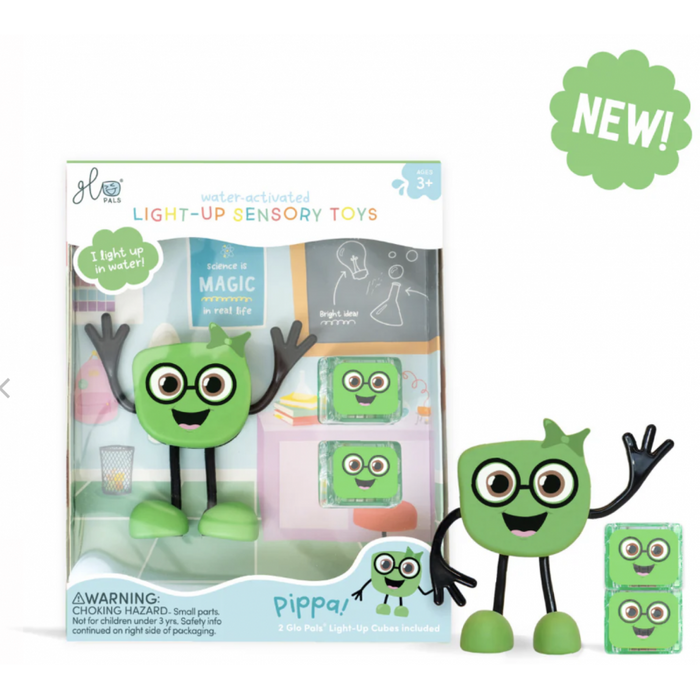 Green cube character with glasses and a bow, next to its packaging and two small light-up cubes.