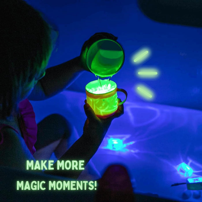 Child pouring glowing green liquid under blue light with light-up cubes and text: Make more magic moments!