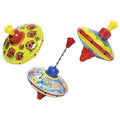 Three metal spinning tops with ladybug, rainbow, and whimsical patterns on a plain white background.