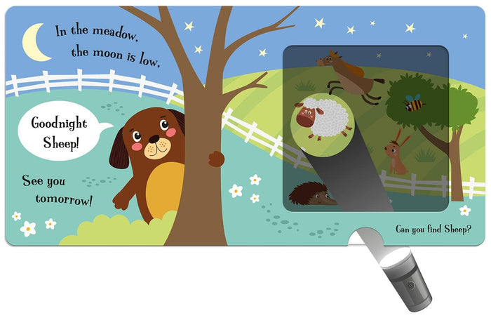 Open board book page with a paper torch revealing a sheep in a dark window beside a cartoon dog and crescent moon.