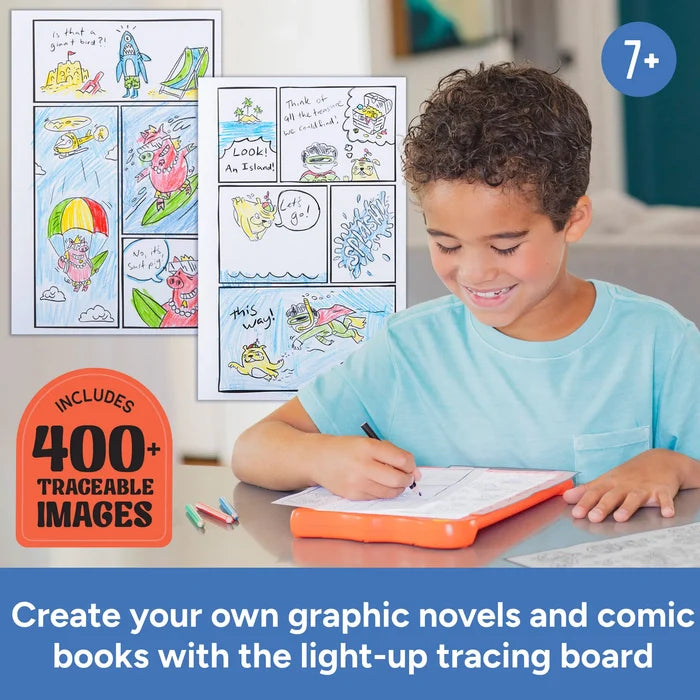 Boy using an orange light-up tracing board to draw comic book pages next to colorful examples.