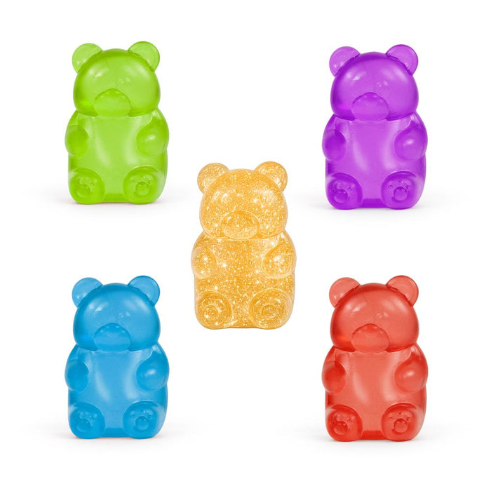Five translucent gummy bear-shaped squishies in green, purple, blue, and red with a glittery yellow bear in the center.