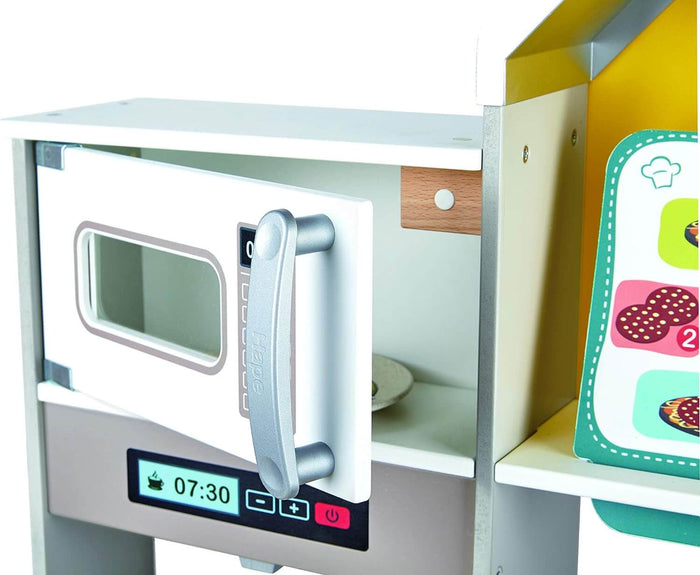 Close-up of a white toy microwave with an open door, grey handle, and a digital display showing 07:30.