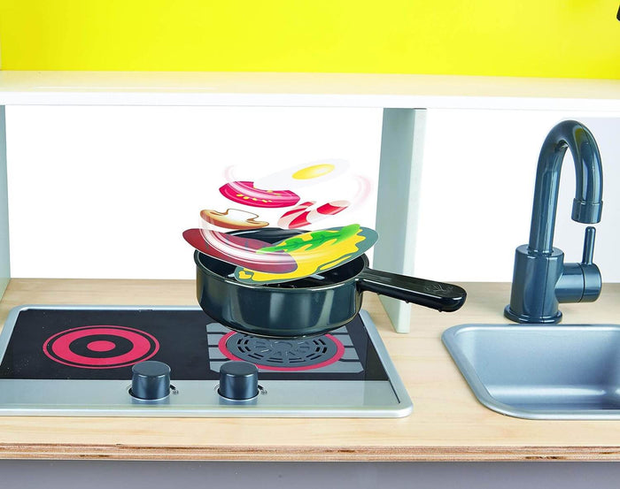 Toy stovetop with a pan. Flat play food pieces float above the pan to demonstrate a fan-powered cooking feature.