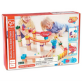 Box for a wooden marble run with orange and red tracks, blue funnels, and dominoes, featuring two kids playing.