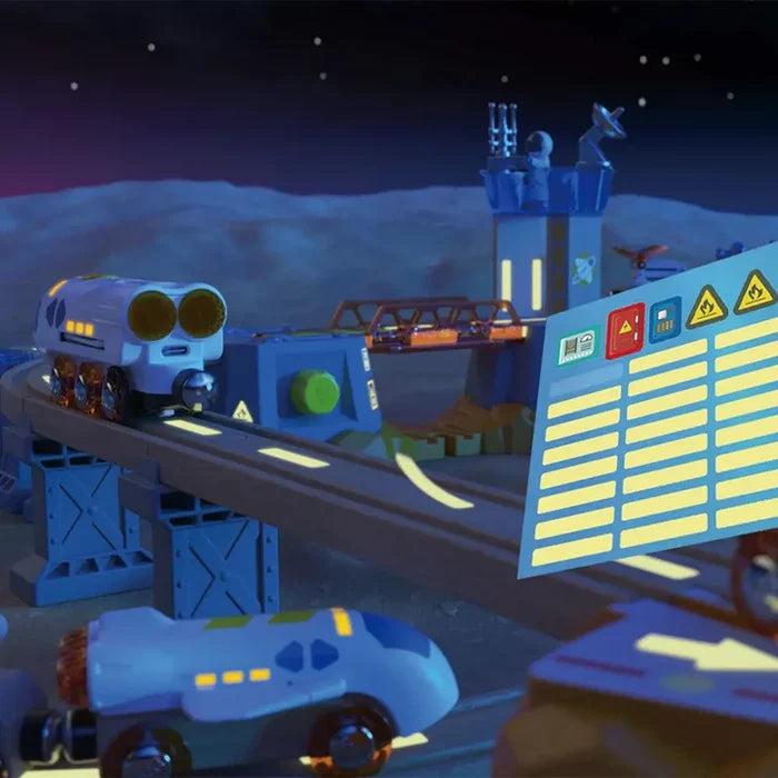 Blue futuristic toy trains on tracks with a space station tower, lunar backdrop, and holographic control panel.