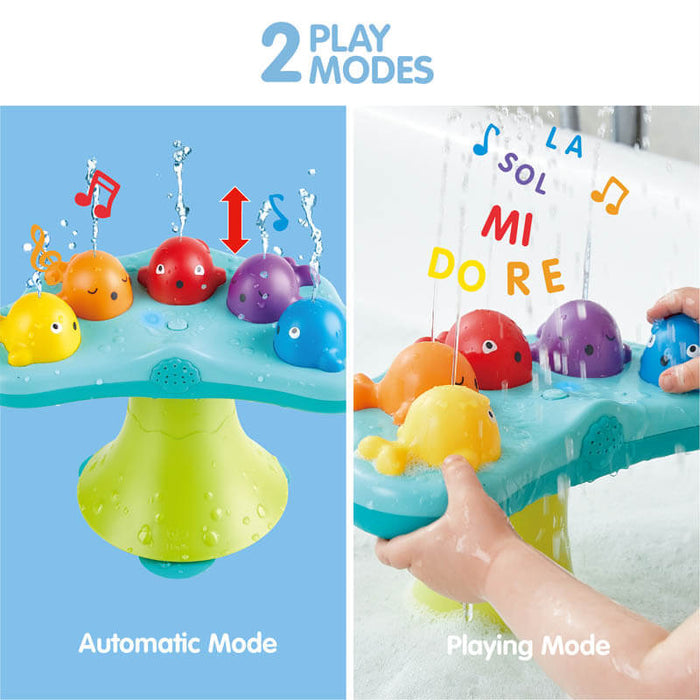 Five colorful whales spray water and music notes on a blue platform with a green base in two interactive modes.
