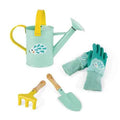 Light green hedgehog watering can, matching gloves, yellow rake, and green trowel with wooden handles.