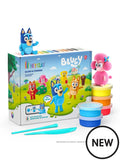 Bluey clay set box with stacked colorful cans, teal sculpting tools, and finished Bluey and pink poodle clay figures.