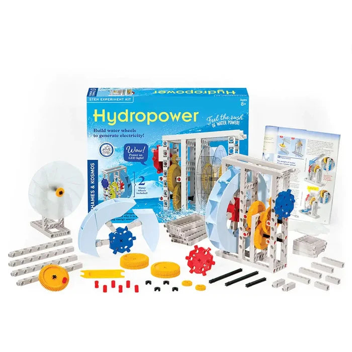 Blue Hydropower STEM kit box with colorful plastic gears, grey beams, water wheel parts, and an open manual.