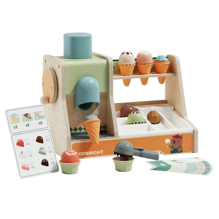 Wooden toy ice cream stand in pastel colors with scoops, cones, scooper, menu, and play money.