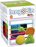 InnyBin box showing a white cube with rainbow elastic bands, textured shapes, and a 10m+ age recommendation.
