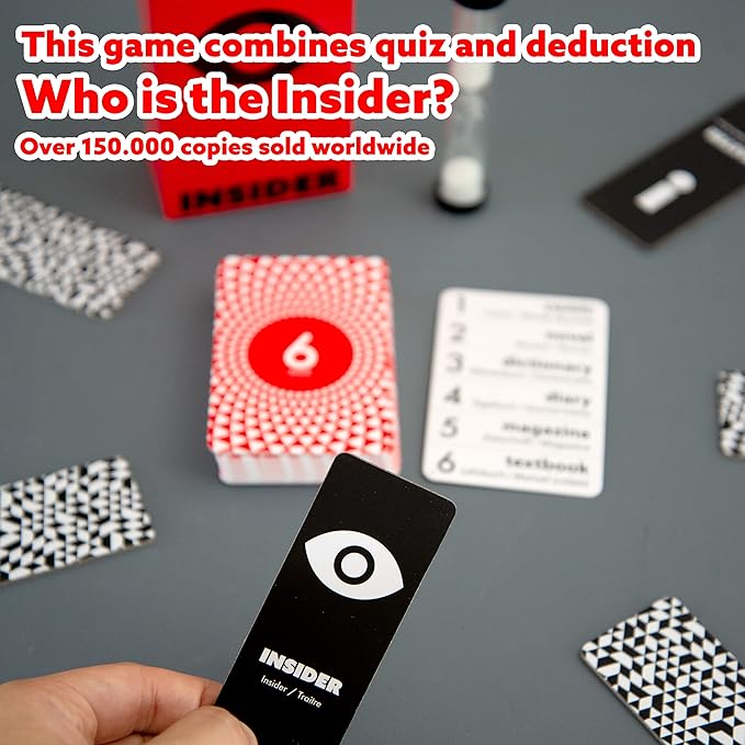 Red game box, a hand holding a black eye card, red patterned cards, a word list, and a sand timer on a grey surface.