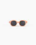 Round peach-colored kids' sunglasses with chunky frames and dark circular lenses, shown from the front on a white background.