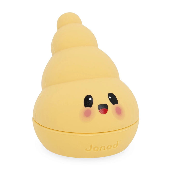 Pale yellow spiral-shaped bath toy with a cute smiling face, pink cheeks, and Janod logo at the base.
