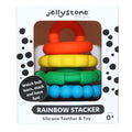 Stacked red, yellow, green, and blue textured silicone rings in a white box with black dots.