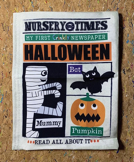 Fabric crinkly newspaper toy for babies featuring Halloween illustrations of a mummy, a bat, and an orange pumpkin.