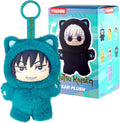 Teal fuzzy cat-ear plush with spiky hair beside a blue Jujutsu Kaisen blind box showing collectible character designs.
